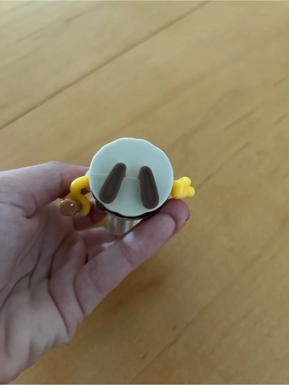 One-Eyed Yellow Action Figure with Brown Staff - Classic Cartoon Style
